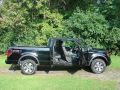 2011 F150 FX4 SuperCab with doors open.