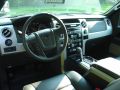 The 2011 Ford F150 FX4, and its well layed out dashboard and steering wheel controls.