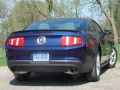 2012 Ford Mustang V6 with view of the rear bumper, decklid spoiler and stainless steel dual exhaust.